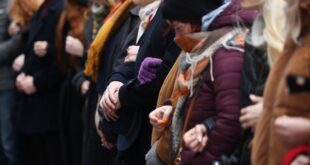 Mourners march hold mass hug to remember Prague shooting victims