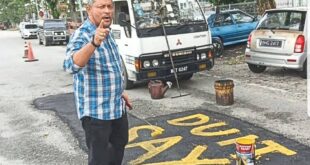 Pothole vigilante takes matters into own hands