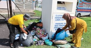 Recycling bins overflowing with uncollected bags of clothing an eyesore