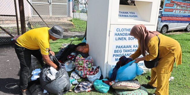 Recycling bins overflowing with uncollected bags of clothing an eyesore