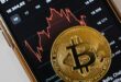 Volatile bitcoin falls from record high as crypto frenzy hits