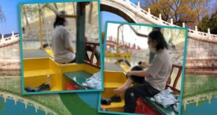 Girl in China dips feet into lake at historic Beijing