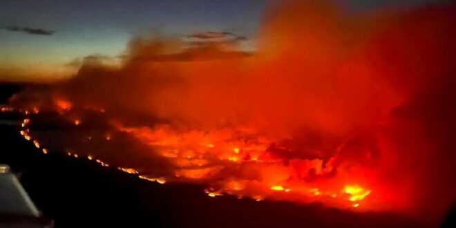 Canadian firefighters battle wildfire sweeping towards BC town