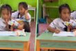 Video of Thailand girl 10 taking notes while feeding baby