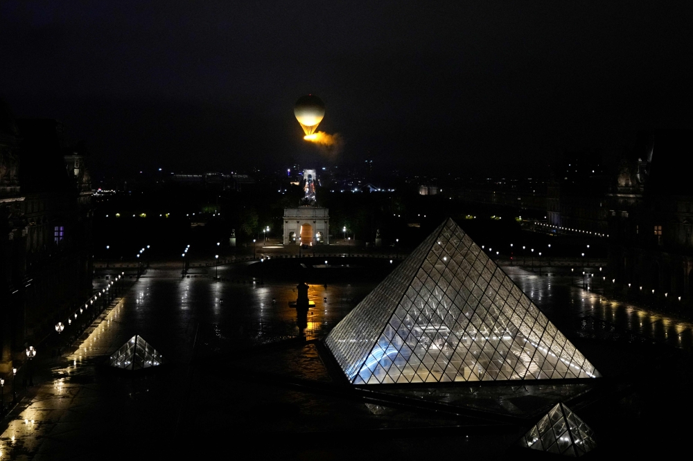 The cauldron, with the Olympic flame lit, lifts off while attached to a balloon during the opening ceremony for the 2024 Summer Olympics in Paris, France, Friday, July 26, 2024. — AFP pic 